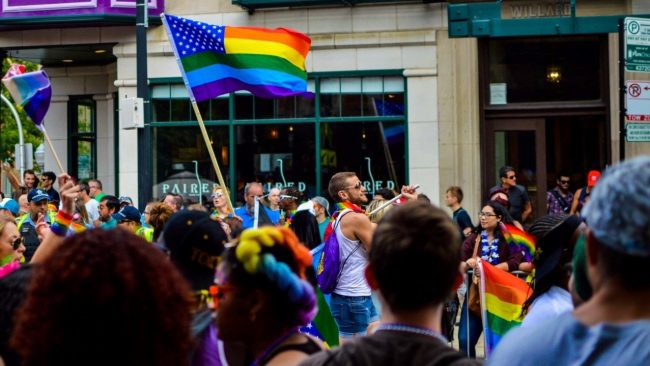 People gathered on the streets with rainbow flags for an LGBTQ event